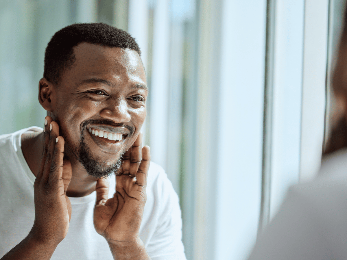 man smiling in mirror
