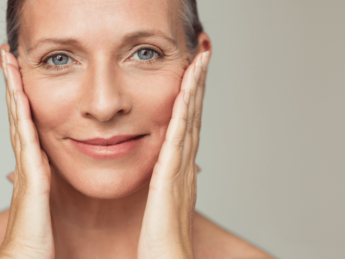 close up photo of woman holding her face